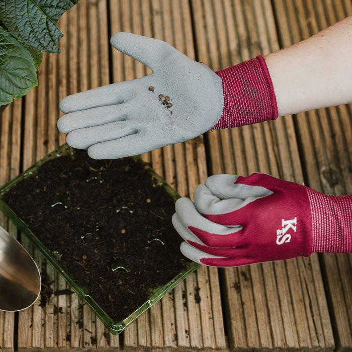 Kent & Stowe All Round Triple Pack Gloves Plum holding seeds to plant