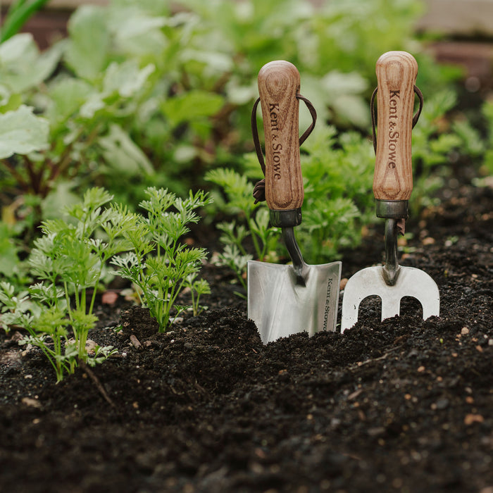 Kent & Stowe Garden Life Stainless Steel Hand Trowel and hand fork in use with soil