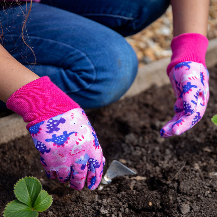 Kent & Stowe Pink Dinosaur Kids Gardening Gloves using hand trowel