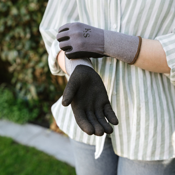 Person wearing black gardening kent and stowe gloves