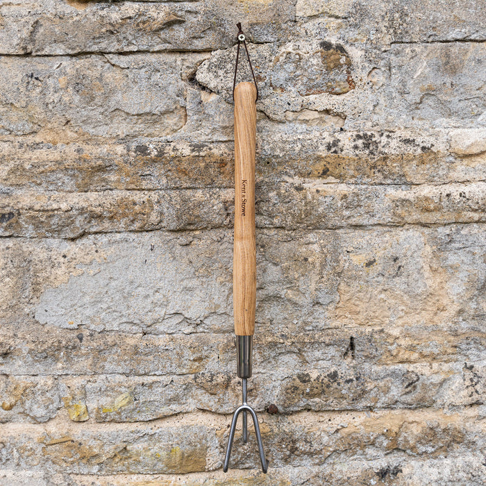 Kent & Stowe Stainless Steel Border 3 Prong Cultivator against wall