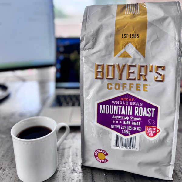 Boyer's Coffee package with a cup of coffee on a desk