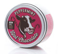 Tin of peppermint hot chocolate with a cow illustration on a white background